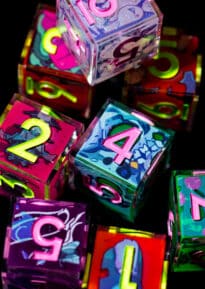 A zooomed-in shot of neon and fluorescent six-sided dice